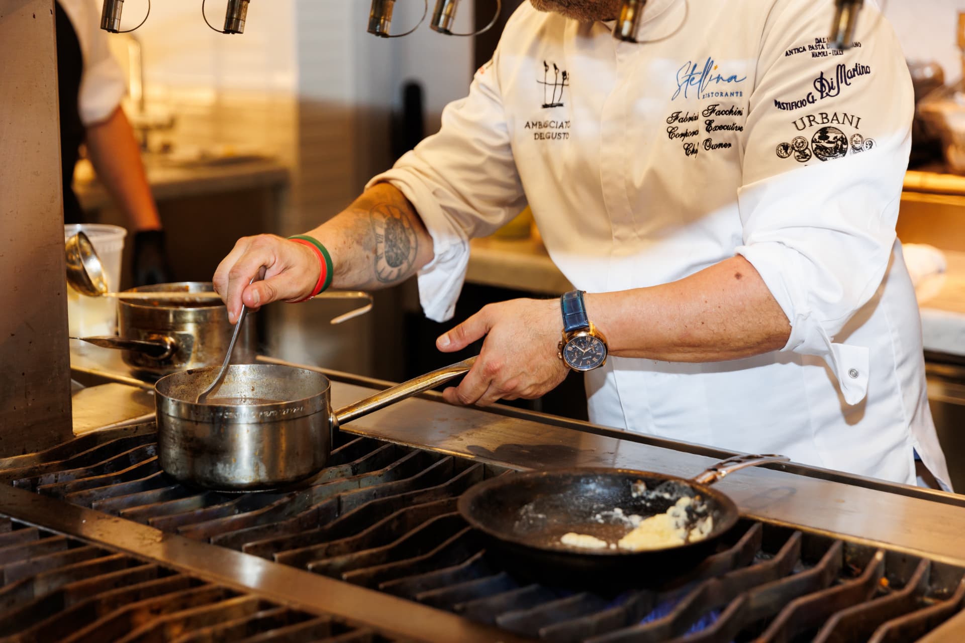 Chef Fabrizio cooking live at an interactive chef station
